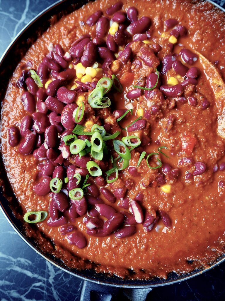 the salsa enchilada seen from above with beans and corn and spring onion