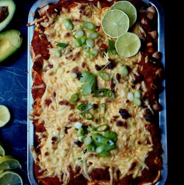 The enchiladas with roasted vegetables seen from above with lime, avocado, coriander, spring onion