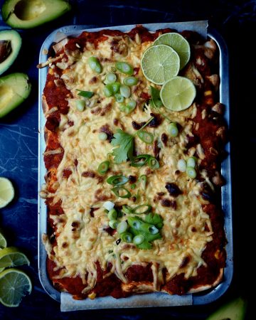 The enchiladas with roasted vegetables seen from above with lime, avocado, coriander, spring onion