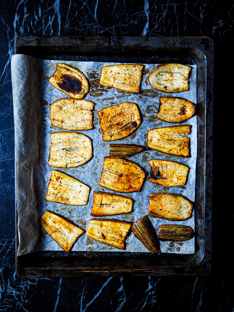 oven tray with baked aubergine slices seen from above